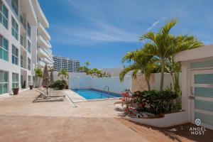 a swimming pool in the courtyard of a building at Condos by Malecon I Breathtaking Ocean View in La Paz