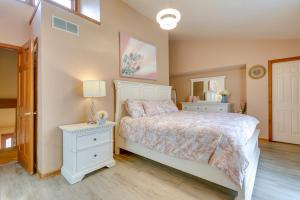 a bedroom with a white bed and a mirror at Lovely Ocean Gate Home Less Than 1 Mi to Beach! in Ocean Gate