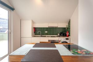 a kitchen with mats on the floor in a room at Casa Esmeralda by Home Sweet Home Aveiro in Aveiro