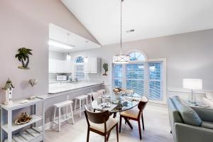 a kitchen and living room with a table and a couch at Riverwalk 301 in Myrtle Beach