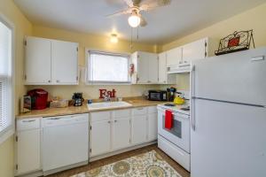 a kitchen with white cabinets and a white refrigerator at Cozy Lake Cabin with Dock in Hot Springs Natl Park in Lake Hamilton