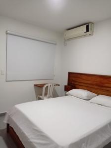 Postel nebo postele na pokoji v ubytování HOTEL SAN ADOLFO