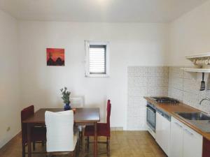 a kitchen with a table and a table and chairs at Apartment Prvic Sepurine II in Prvić Šepurine
