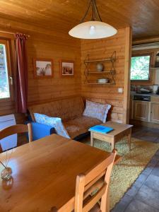 a living room with a table and a couch at Chalet l'Herminette in Saint-Jorioz