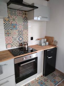 a kitchen with a black and white stove top oven at Leszczynowe Zacisze in Wiele