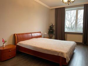 a bedroom with a large bed and a window at Eksporta Street Quiet Old Riga Apartment in Rīga