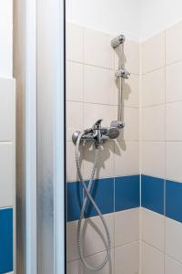 a shower with a hose in a bathroom at Night Sky Studio - Brno in Brno