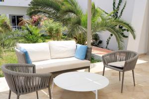 a living room with a couch and two chairs at Hotel Riad Meninx Djerba in Djerba