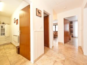 a hallway of a apartment with a door and a kitchen at Holiday home Reichenbach in Bayerstetten