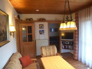 a living room with a couch and a table and a tv at Holiday home Karwendel in Füssen