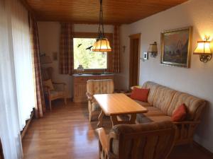 a living room with a couch and a table at Holiday home Karwendel in Füssen