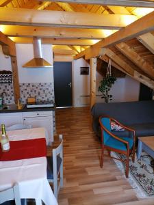 a kitchen and a living room with a table and chairs at Apartman Tonka in Otočac