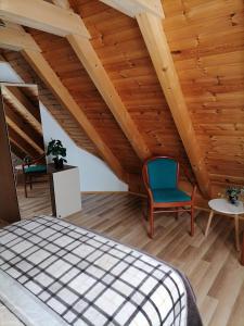 a bedroom with a bed and a wooden ceiling at Apartman Tonka in Otočac