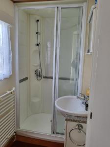a bathroom with a shower and a sink at Beautiful Caravan in Ingoldmells +12 photos