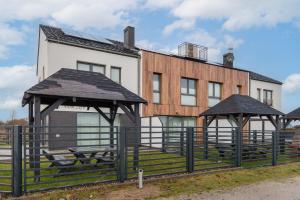 a building with two gazebos in front of it at Exclusive Zefir Sauna & Grill in Międzywodzie