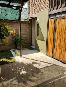 an entrance to a house with a wooden door at Alojamiento Entero, Aeropuerto Ezeiza in Ezeiza