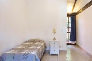 A bed or beds in a room at Aconchegante casa prox. a praia em Geribá/Búzios