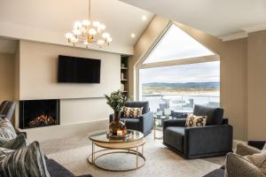 a living room with a fireplace and a tv at Atlantic View in Portstewart
