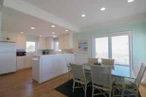 a kitchen and dining room with a table and chairs at Claire's Rendezvous in Tybee Island