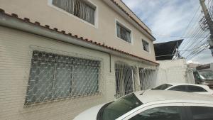 a white car parked in front of a building at Apt(2) no centro de VR tudo perto até 7 pessoas in Volta Redonda