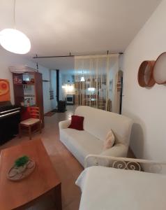 ein Wohnzimmer mit einem weißen Sofa und einem Tisch in der Unterkunft Casa do Moleiro in Santiago do Cacém