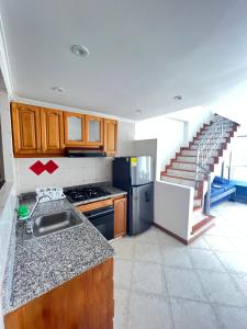 a kitchen with a sink and a staircase at El Peñon del Rodadero Apartamento Playa Rodadero 8 in Puerto de Gaira