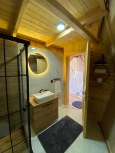 a bathroom with a sink and a glass door at LİMKHONA DOME - CHALET in Çamlıhemşin