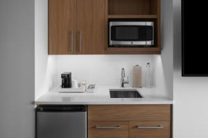 a kitchen with a sink and a microwave at Element by Marriott San Antonio Riverwalk in San Antonio +46 photos