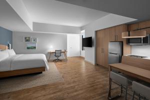 a hotel room with a bed and a kitchen at Element by Marriott San Antonio Riverwalk in San Antonio