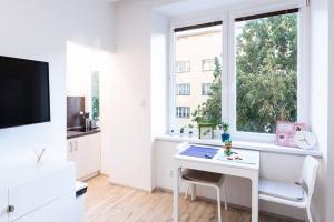 cocina blanca con escritorio blanco y ventana en Tranquility Apartement - Brno, en Brno