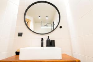 a bathroom with a white sink and a mirror at Urban Downtown Suite Xanthi - MenoHomes 4 in Xanthi