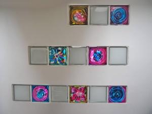 a white wall with four colorful glass plates on it at Fern Lodge Angus, Kirriemuir in Angus