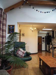 a living room with a couch and a table at Fern Lodge Angus, Kirriemuir in Angus