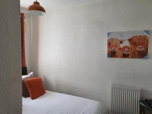 a room with a bed with a picture on the wall at 140 Bond in Blackpool