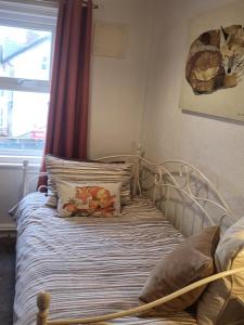 a bedroom with a bed with pillows and a window at 140 Bond in Blackpool