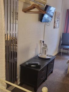 a room with a black dresser with a lamp on it at 140 Bond in Blackpool +30 photos
