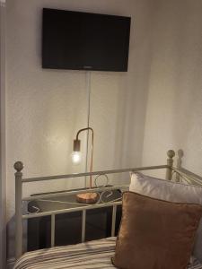 a bedroom with a bed with a television on the wall at 140 Bond in Blackpool