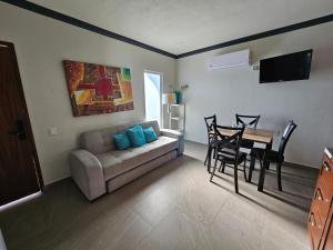 a living room with a couch and a dining room table at DEPARTAMENTOS SUITES HOTEL LITO in Nuevo Vallarta