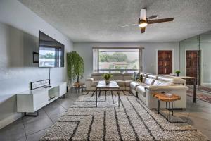 a living room with a couch and a tv at Private Pool and Dock Coconut Creek Home! in Coconut Creek