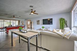 a living room with a couch and a table at Private Pool and Dock Coconut Creek Home! in Coconut Creek