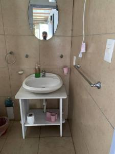 a bathroom with a sink and a mirror at Casa Contenedor y espacio verde in Paysandú