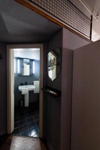 a bathroom with a sink and a mirror at Studio Neve in Bologna