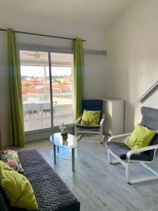 a living room with a couch and a table at Coup de cœur à Sanary sur Mer in Sanary-sur-Mer