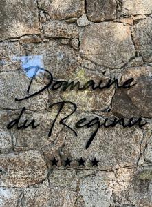 a sign that says dancing in korea on a stone wall at Domaine du Reginu in Santa-Reparata-di-Balagna