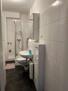 a white bathroom with a sink and a toilet at Zentral, gemütlich, Messe nah! BE1L in Essen