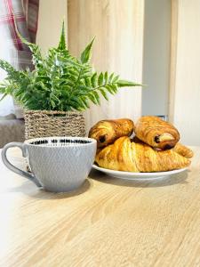 a table with a plate of croissants and a cup at Sea Breeze in Scarborough