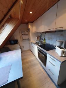 a kitchen with white cabinets and a counter top at Ferienwohnung Hänel in Antonshöhe