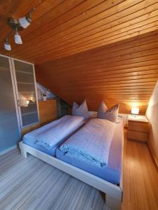 sypialnia z łóżkiem i drewnianym sufitem w obiekcie Ferienwohnung Hänel w mieście Antonshöhe