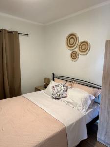 a bedroom with a bed with a pillow on it at Village escape: στην Πρέβεζα in Flámpoura +29 photos