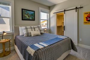 a bedroom with a bed and a window at Stylish Montana Vacation Rental with Private Hot Tub in Red Lodge